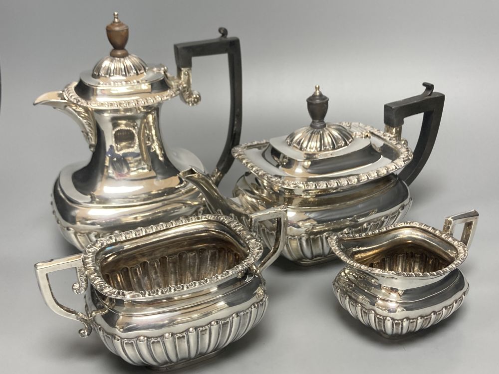 A George V demi fluted silver four piece tea set by Charles Boyton & Son Ltd, London 1918 and 1922,